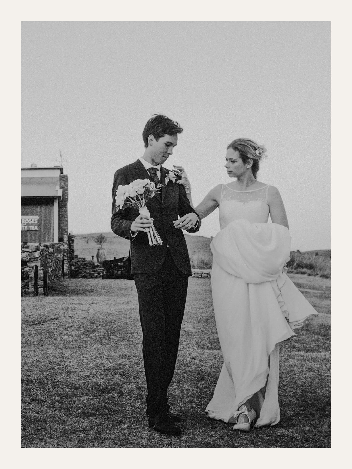 Bride and groom walking together after the ceremony, holding flowers. Ben Viljoen Photography
