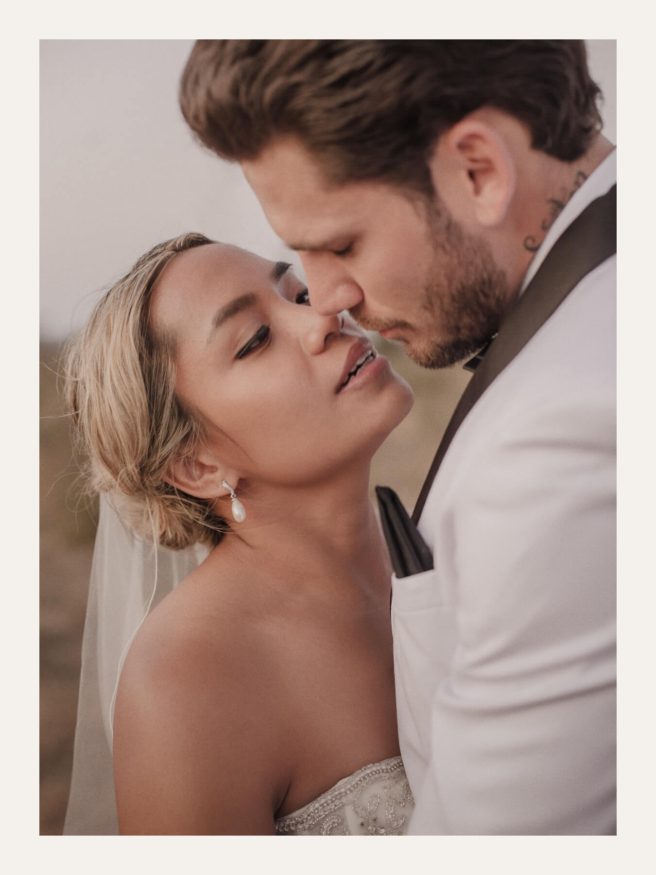 Bride and groom kissing, photographed close in warm evening light. Ben Viljoen Photography